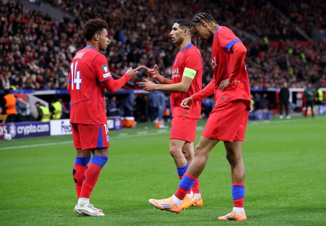 Desire Doue, Bradley Barcola and Achraf Hakimi celebrate PSG's fourth goal of the evening against Bayer Leverkusen.