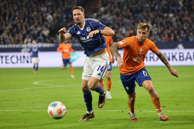 Luca Marseiler of SV Darmstadt 98 (R) challenges Janik Bachmann of FC Schalke 04 (L) during the 2. Bundesliga match