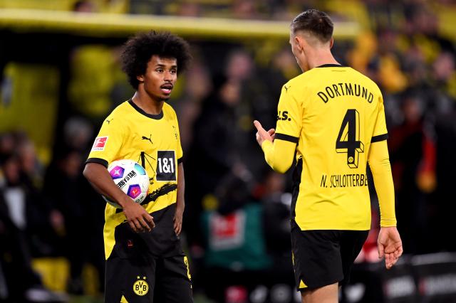 Karim Adeyemi and Nico Schlotterbeck of Borussia Dortmund interact during a Bundesliga match. Karim Adeyemi and Nico Schlotterbeck of Borussia Dortmund interact during a Bundesliga match.