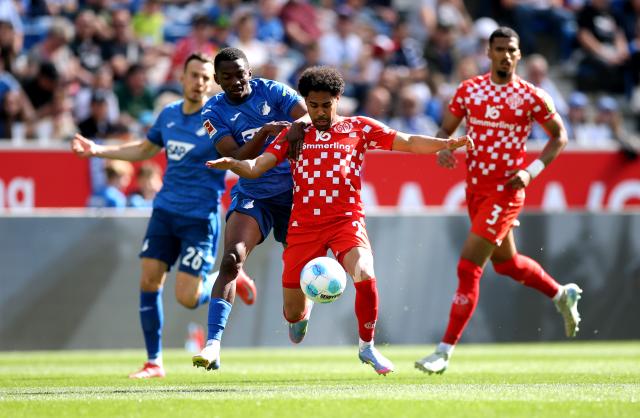 Phillipp Mwene of Mainz 05 is challenged by Bazoumana Toure ofHoffenheim, Apr 12 2025