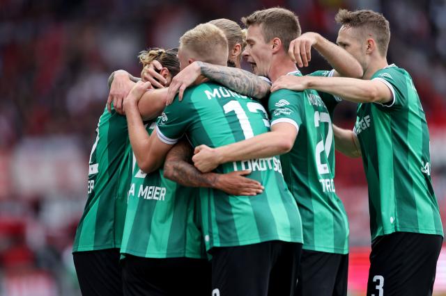 Oliver Batista Meier of Münster celebrates the first goal with his team mates during the 2. Bundesliga match vs. Nürnberg