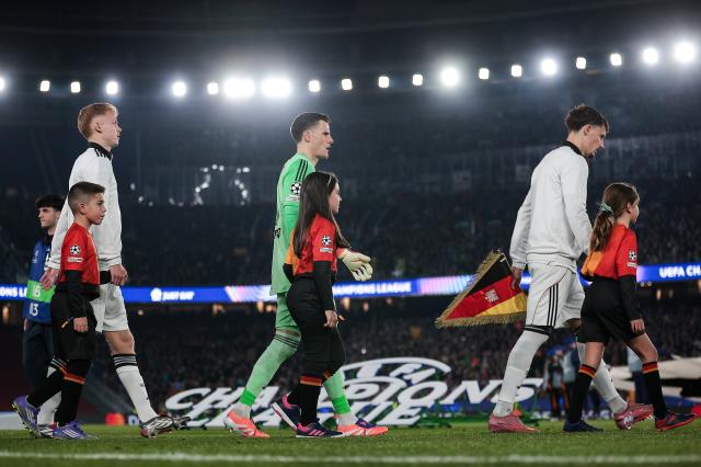 Eintracht Frankfurt players walking onto the pitch.