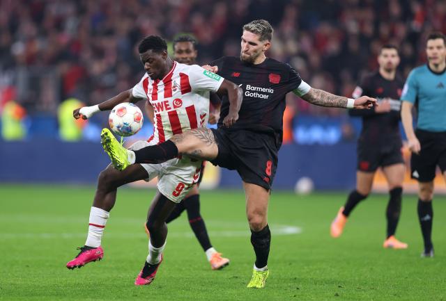 Leverkusen's Robert Andrich in a duel with Köln's Ragnar Ache.
