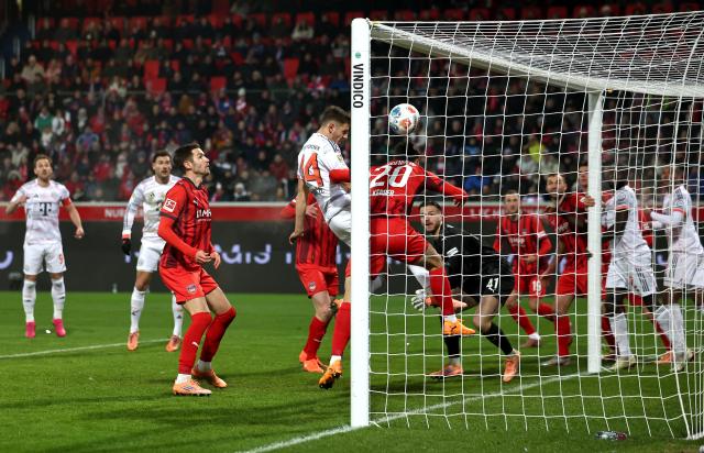 Josip Stanisic of Bayern Munich opens the scoring against Heidenheim.