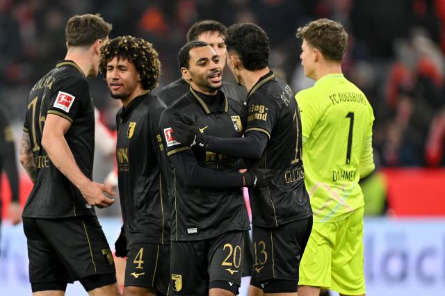 FC Augsburg players celebrating after their surprising win over Bayern Munich.