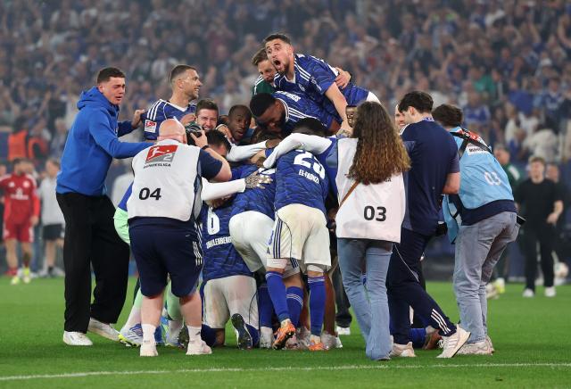 Schalke players celebrate following their promotion to the Bundesliga 
