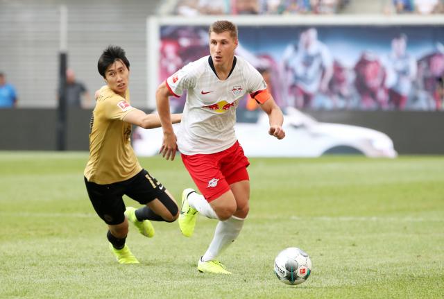 Daichi Kamada (left) chasing Willi Orban.