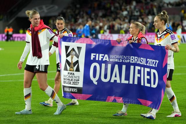 Players of Germany celebrate with a banner 