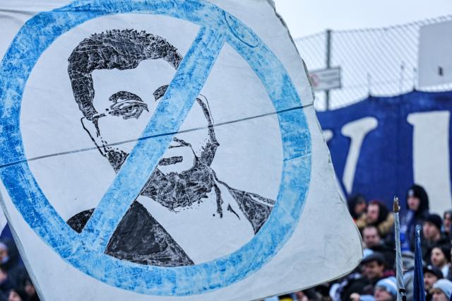 A banner showing 1860 Munich club investor Hasan Ismaik with his face crossed.