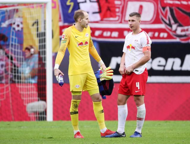 RB Leipzig captain Willi Orban (right) speaks to Peter Gulacsi.