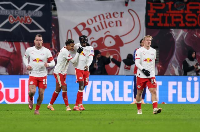 Nusa celebrates a goal with RB Leipzig teammate Yan Diomande.