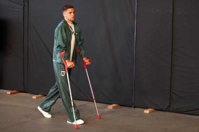 Christoph Baumgartner arriving on crutches for Austria's World Cup opener against Jordan.
