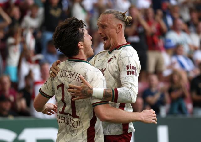 Michael Gregortisch and Marius Wolf celebrating for Augsburg.