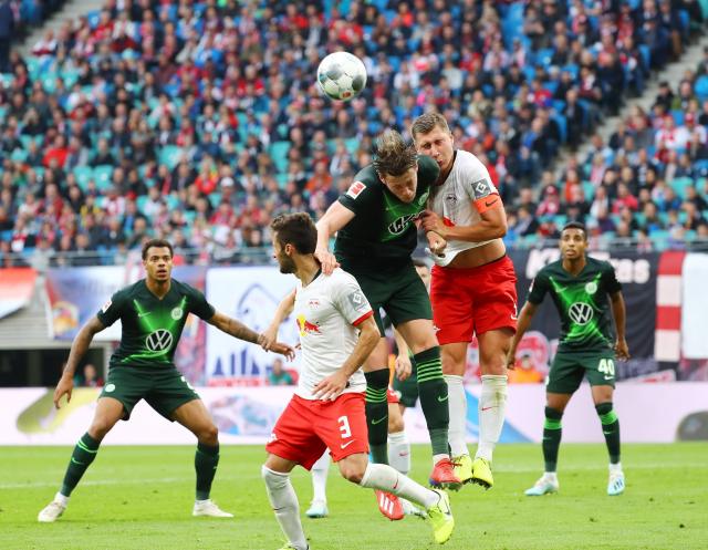 Wout Weghorst and Willi Orban go up for a header.