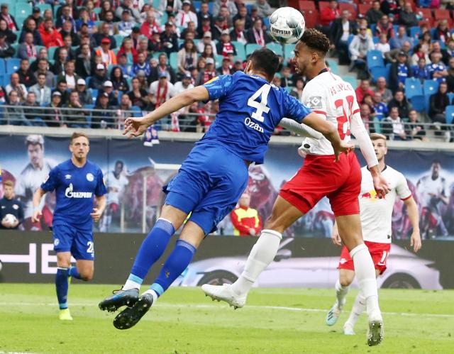 Ozan Kabak (left) goes up for a header. 