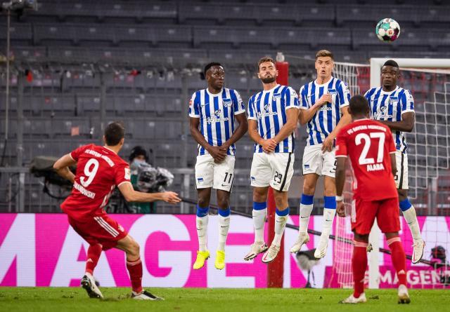 Robert Lewandowski (left) taking a free kick.