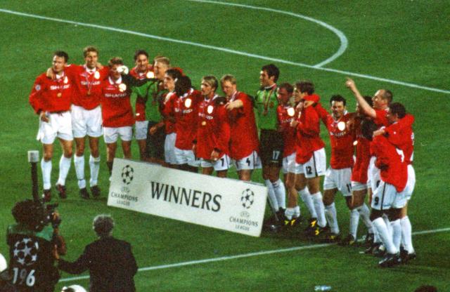 Manchester United players celebrate after winning the Champions League final in 1999.