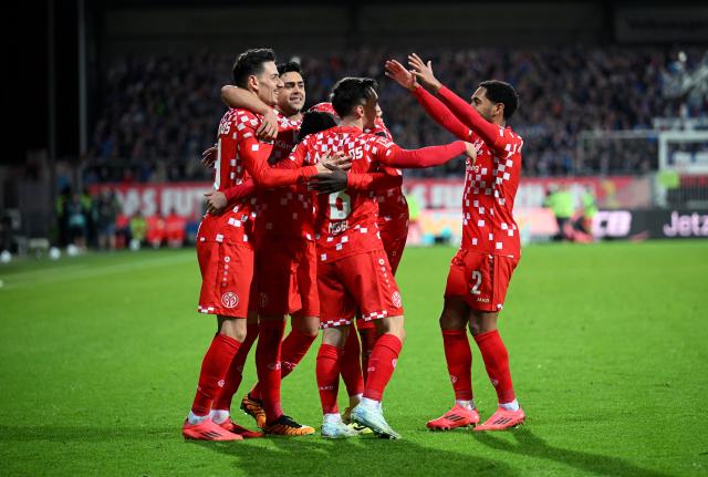 Mainz teammates celebrate scoring the decisive goal against Kiel Sunday. Mainz teammates celebrate scoring the decisive goal against Kiel Sunday.