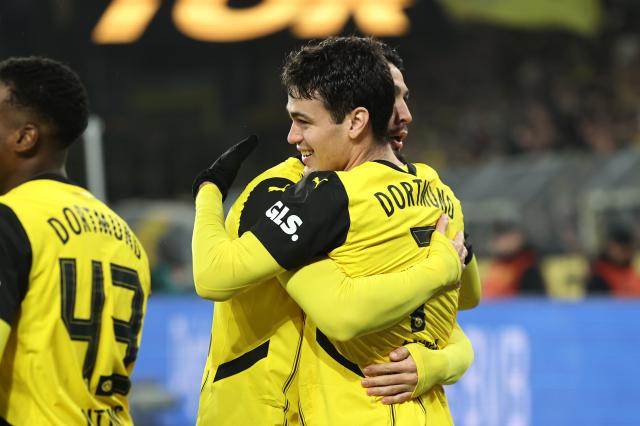 BVB captain Emré Can hugs Giovanni Reyna after Reyna's goal last night. .