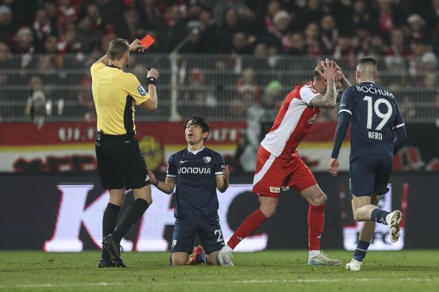 Match official Martin Petersen shows Miyohsi the red card on Saturday. 