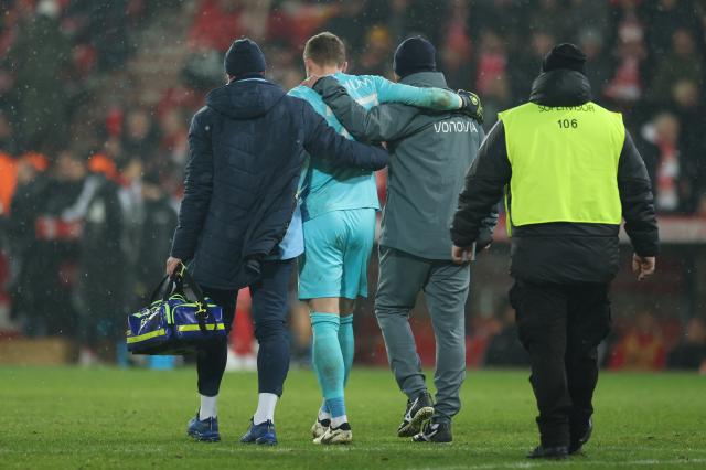 Patrick Drewes being helped off the pitch after a flare throwing incident caused a disruption in play. 